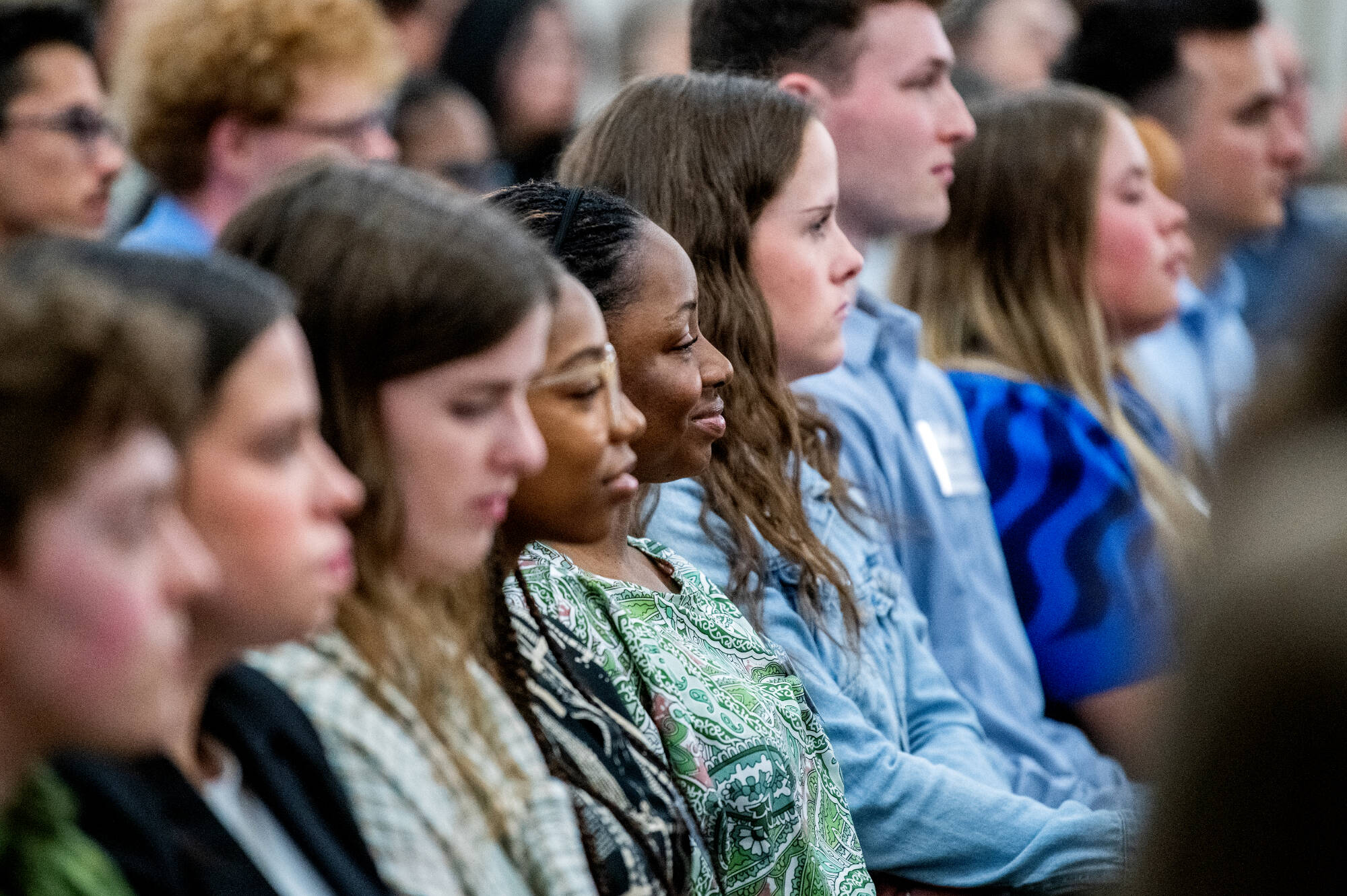 Students listening at a ceremony
